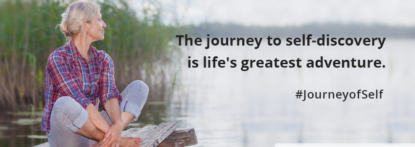 A woman sits by the water contemplating her satisfaction with the various aspects of her life as part of the Journey Of Self-Discovery. #JourneyofSelf