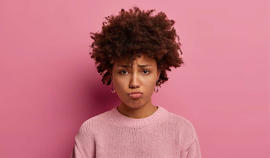 Lady pouting with pink background