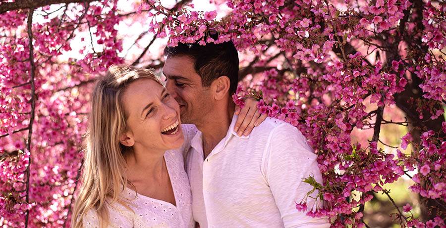 Couple hugging under the cherry blossoms