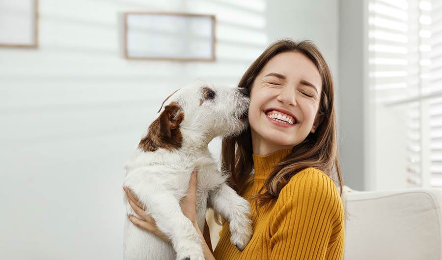 Woman cuddling with a pet