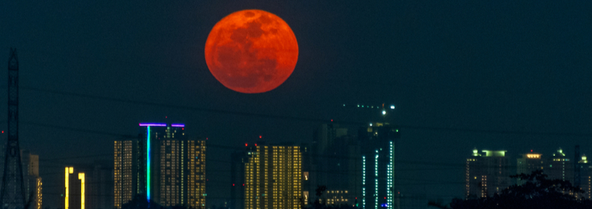 Full Hunter's Moon over City